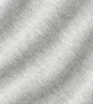 Close-up of the Crown Comfort Pullover by Peter Millar, showcasing its light grey, textured fabric with a subtle diagonal ribbed pattern. The material is soft and slightly heathered, delivering sweatshirt-like comfort—ideal for a lightweight layer or quarter-zip pullover.