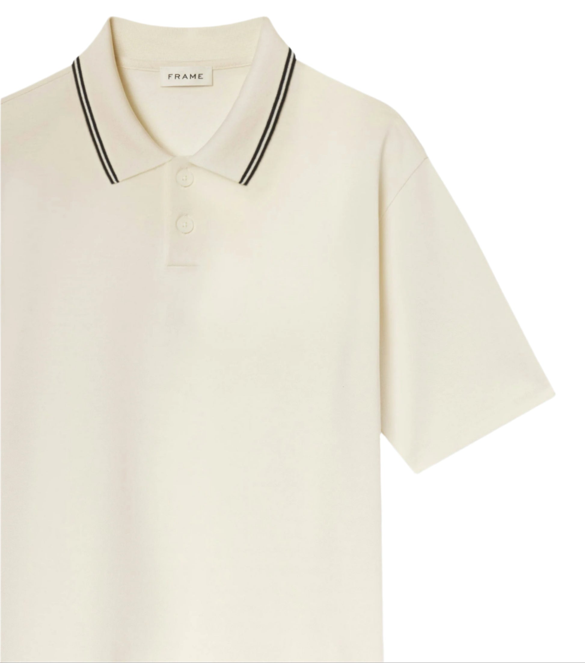 The Frame Light Pique Polo is an off-white, short-sleeve cotton shirt with black double stripes on the collar, a two-button placket, and the "FRAME" label inside—an everyday essential with timeless style.