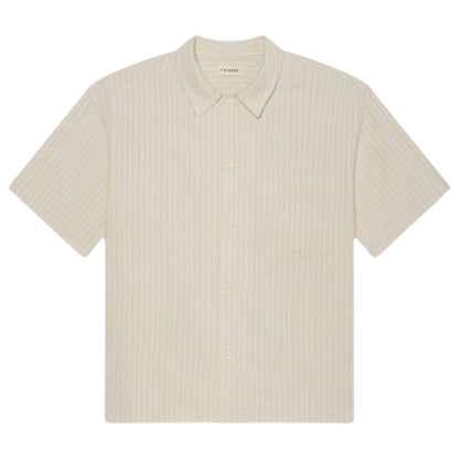The Frame Jacquard Cotton Short-Sleeved Shirt features a breathable cream cotton fabric, subtle vertical stripes, button-up front, and chest pocket—an essential summer piece laid flat on a white background.