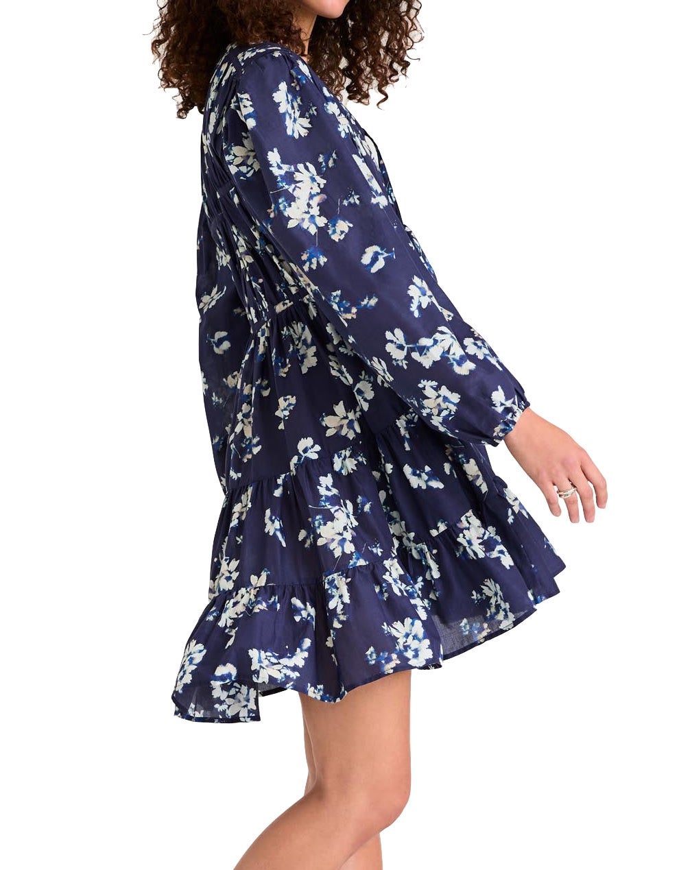 A person in a Merlette Lasse Indigo Floral Dress by Merlette New York stands against a plain, white background.