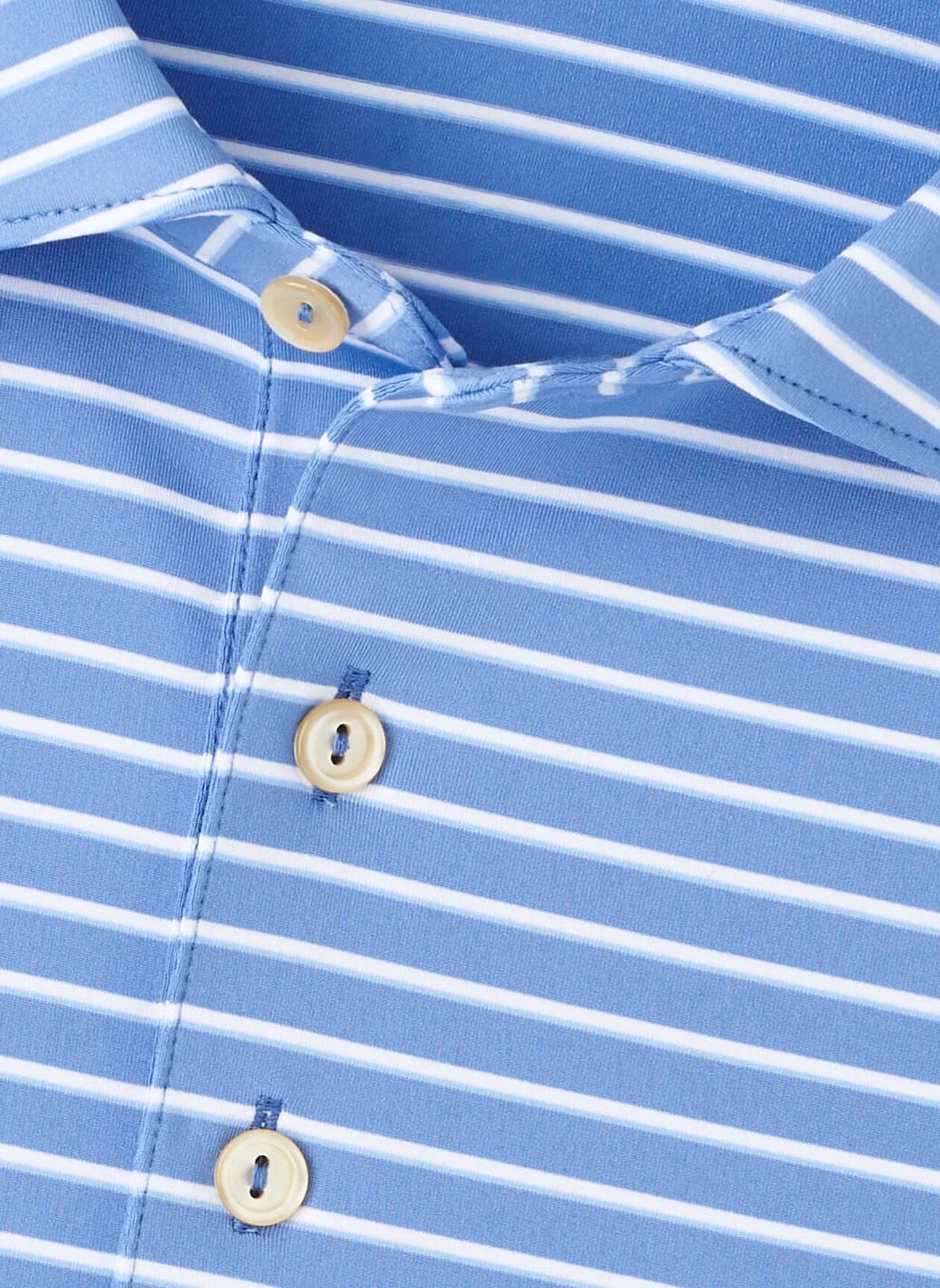 Close-up of the Peter Millar Dunnes Performance Jersey Polo, featuring a blue color with white horizontal stripes, three white buttons, and crafted from four-way stretch fabric for ultimate comfort.