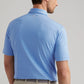A man shown from the back wears a Peter Millar Dunnes Performance Jersey Polo in light blue and white stripes with UPF 50+ protection, paired with beige pants.