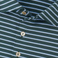 Close-up of a green Peter Millar Dunnes Performance Jersey Polo with white stripes and three beige buttons, featuring four-way stretch for comfort and UPF 50+ sun protection.