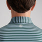 Back view of a person in the Peter Millar Dunnes Performance Jersey Polo, green and white striped, with four-way stretch and a small circular crown logo below the collar.