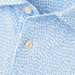 Close-up of the Peter Millar Oyster Shooter Performance Jersey Polo, a light blue shirt with a small repeating geometric and anchor pattern, white buttons, and four-way stretch for enhanced comfort.