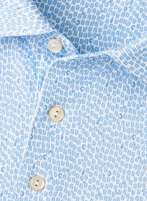 Close-up of the Peter Millar Oyster Shooter Performance Jersey Polo, a light blue shirt with a small repeating geometric and anchor pattern, white buttons, and four-way stretch for enhanced comfort.