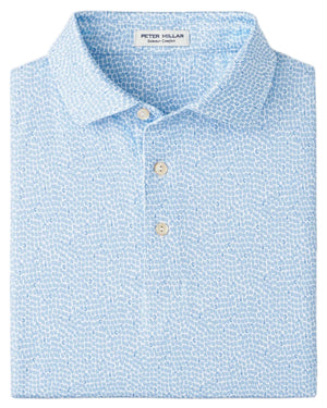 A folded light blue Peter Millar Oyster Shooter Performance Jersey Polo with a subtle white pattern, two visible buttons, and four-way stretch for easy movement.