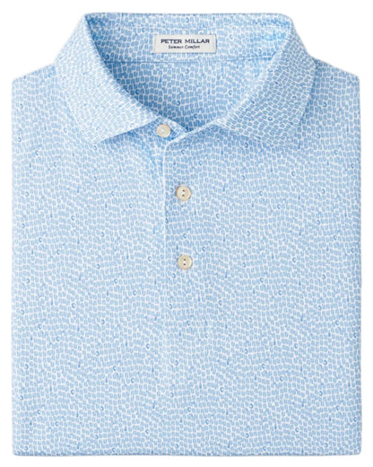 A folded light blue Peter Millar Oyster Shooter Performance Jersey Polo with a subtle white pattern, two visible buttons, and four-way stretch for easy movement.