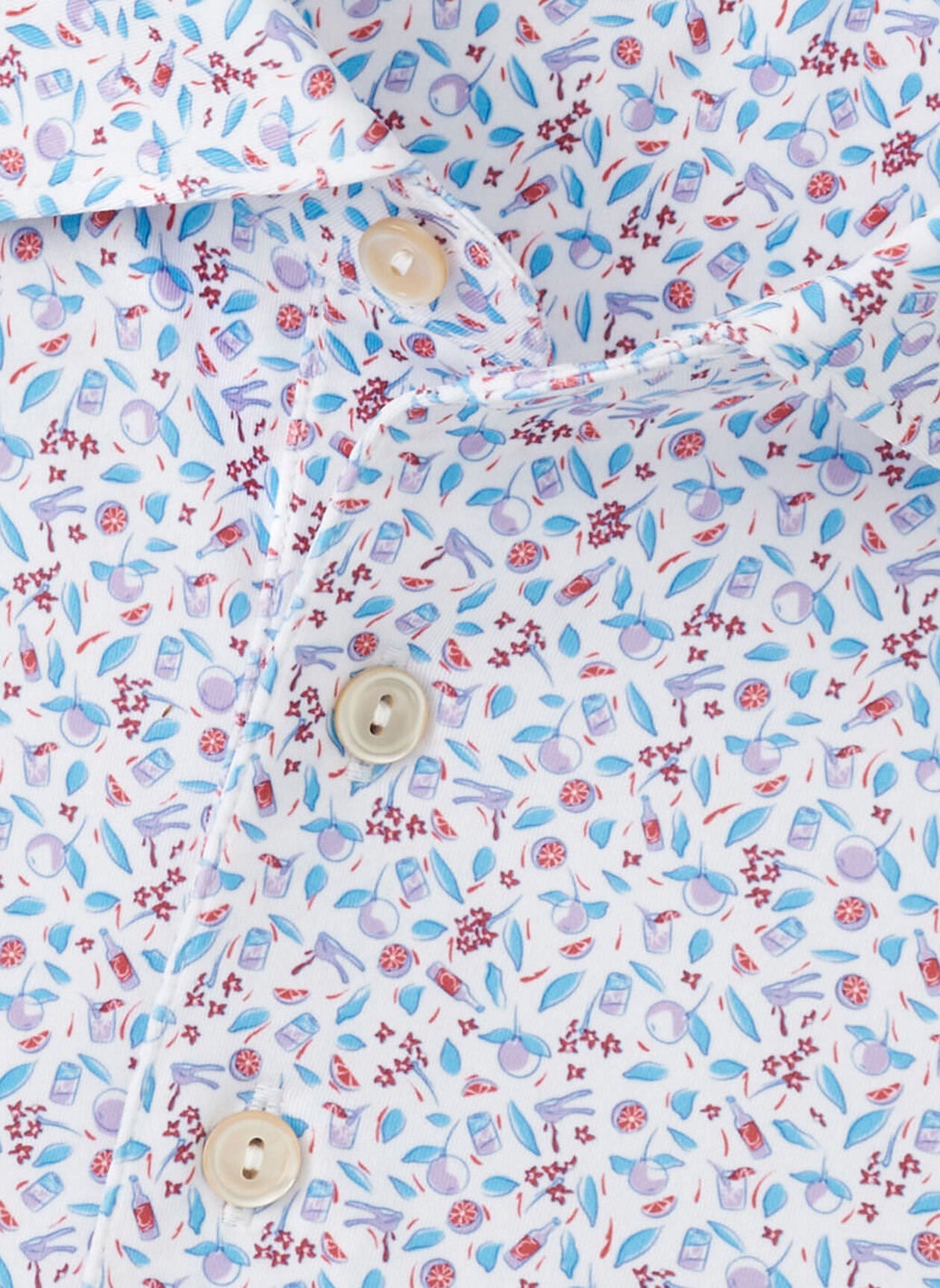 Close-up of the Peter Millar Orange Crush Performance Jersey Polo, featuring a vibrant science-themed pattern with microscopes, atoms, flasks, four-way stretch fabric, and cream-colored buttons.