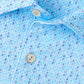 Close-up of the Peter Millar Featherweight Pineapple Mosaic Performance Polo, a light blue patterned golf shirt with a collar and two white buttons, made from lightweight performance fabric for comfort.