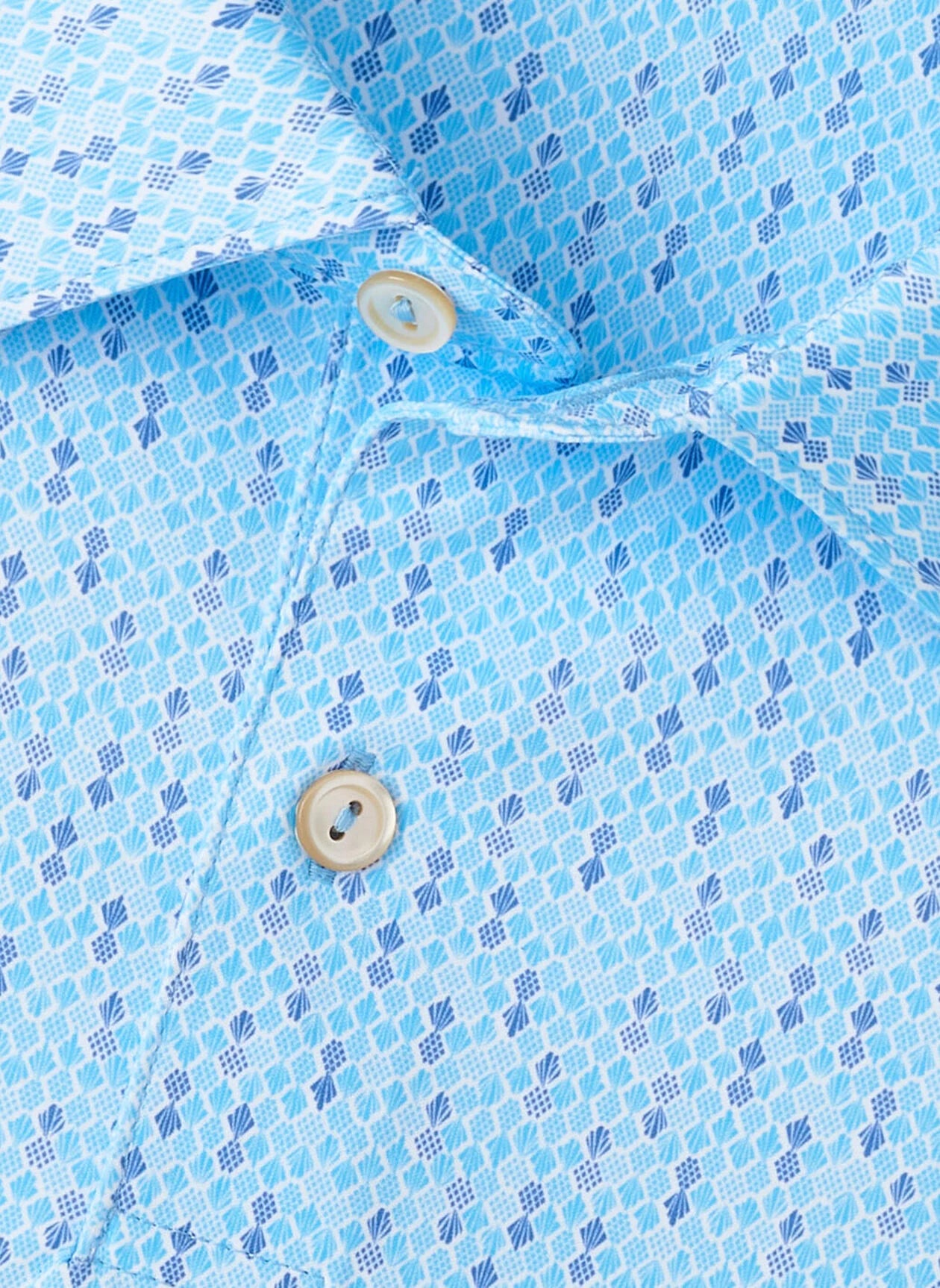 Close-up of the Peter Millar Featherweight Pineapple Mosaic Performance Polo, a light blue patterned golf shirt with a collar and two white buttons, made from lightweight performance fabric for comfort.