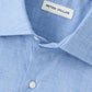 Close-up of a light blue Peter Millar Highlands Soft Twill Cotton Sport Shirt, featuring a spread collar, top button, and brand label.