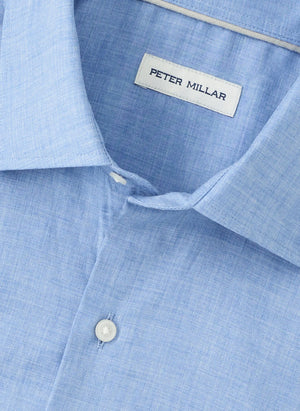 Close-up of a light blue Peter Millar Highlands Soft Twill Cotton Sport Shirt, featuring a spread collar, top button, and brand label.