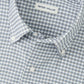 A close-up of a blue and white checkered Cashiers Performance Twill Sport Shirt by Peter Millar, featuring the brand’s label inside the collar.