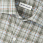 Close-up of the Peter Millar Whitecap Performance Flannel Sport Shirt, featuring a green, blue, and brown plaid pattern in lightweight fibers, with button details and collar—your ideal fall shirt.