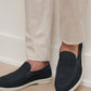 A pair of feet wearing the Peter Millar Excursionist Nubuck Venetian Loafer showcases lightweight versatility and timeless style.