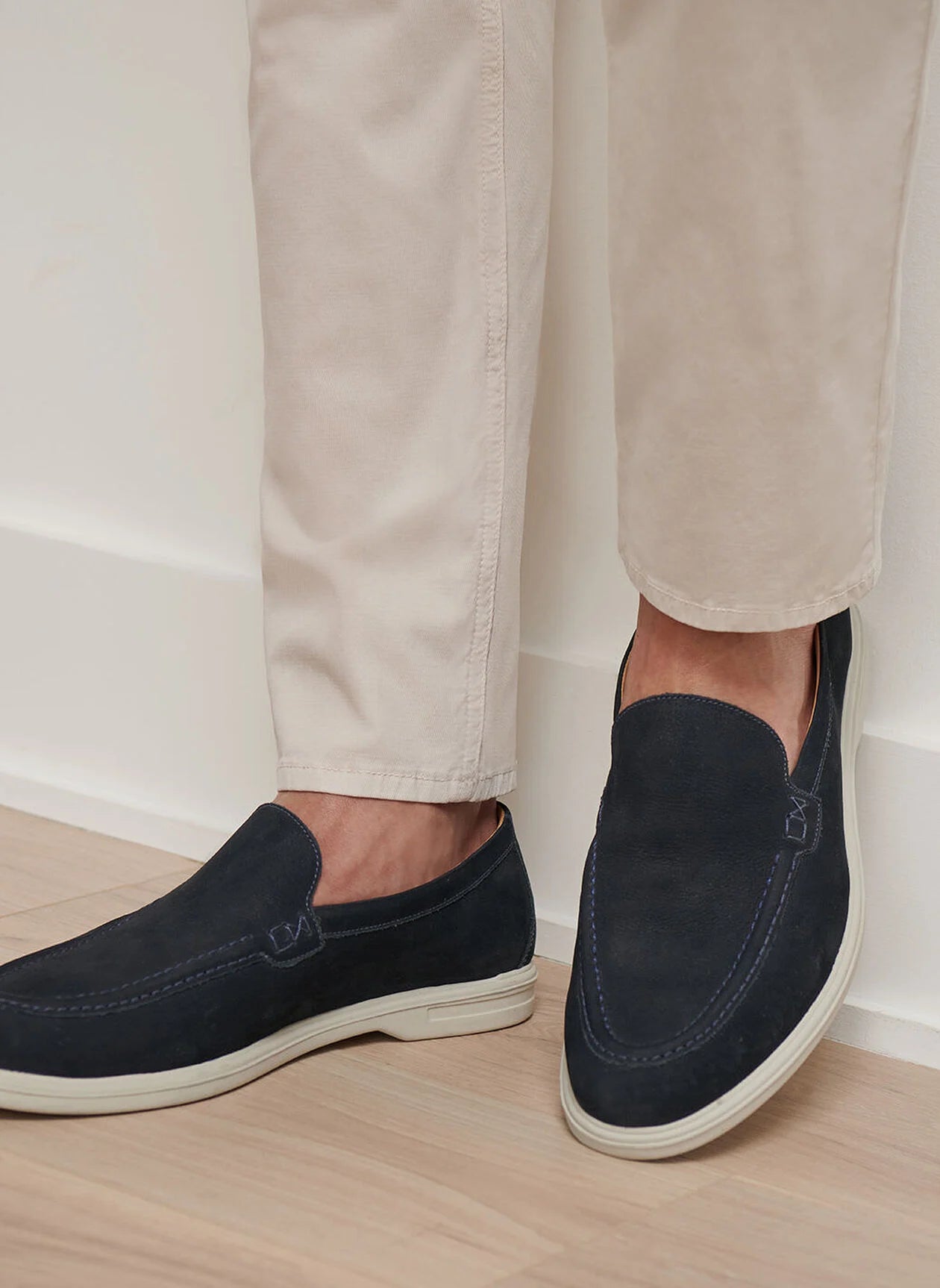 A pair of feet wearing the Peter Millar Excursionist Nubuck Venetian Loafer showcases lightweight versatility and timeless style.