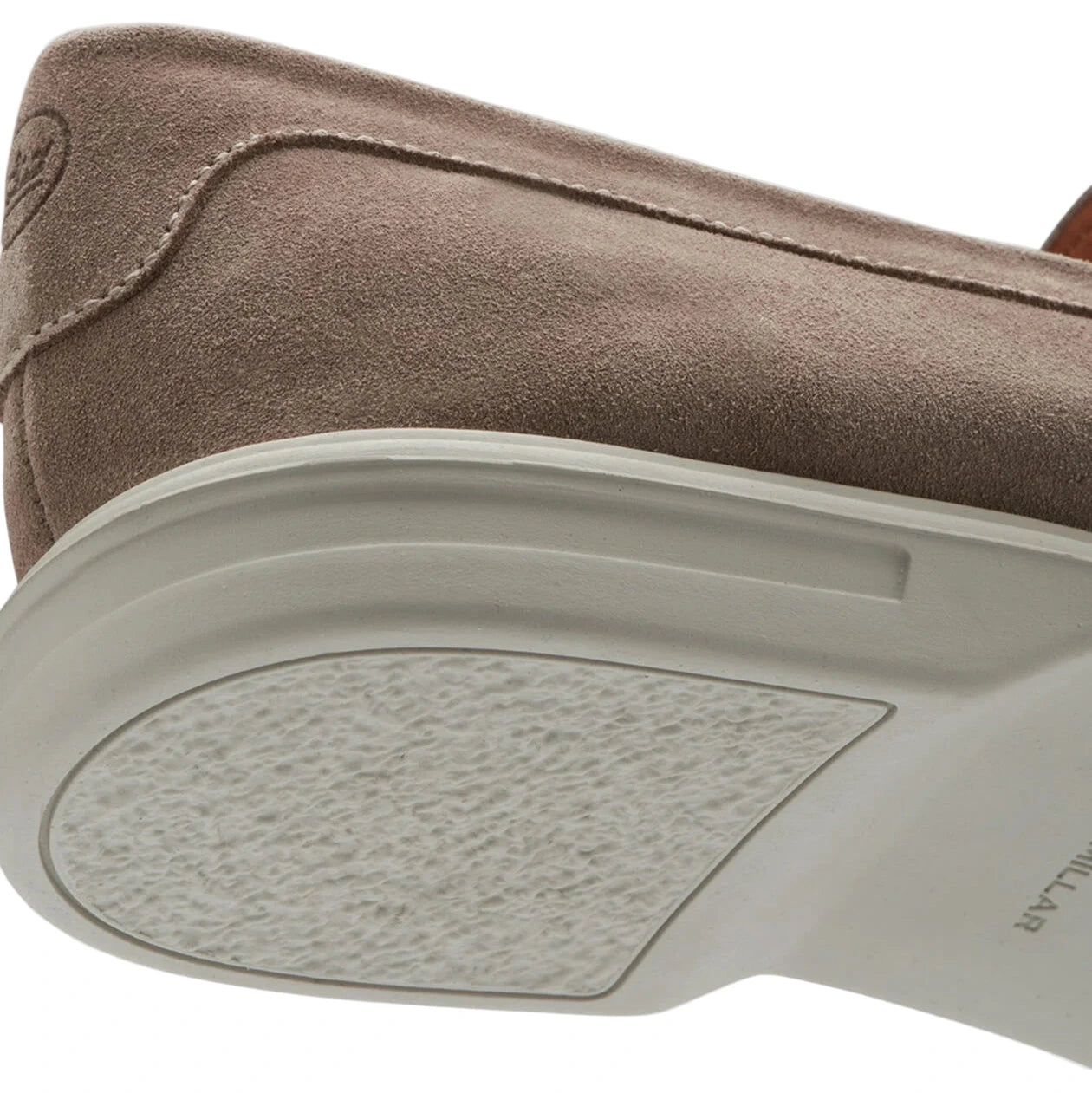 Close-up of the heel and sole of the Peter Millar Excursionist Penny Loafer in beige suede, highlighting its white, textured, lightweight EVA outsole.