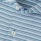 Close-up of the Peter Millar Chase Performance Jersey Polo, featuring green, blue, and white horizontal stripes, a collared neckline with two white buttons, and four-way stretch for comfort.