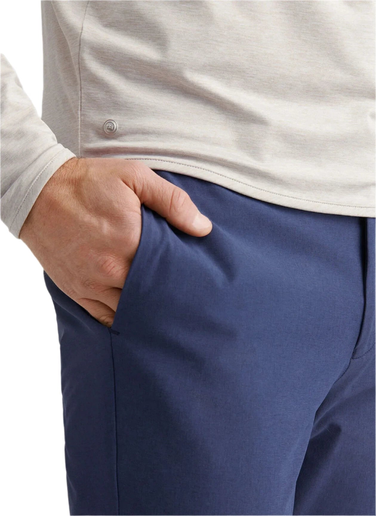 A person wearing a Peter Millar Stealth Performance Quarter-Zip and blue pants stands with one hand in their pocket.