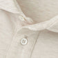 Close-up of the Peter Millar Amble Long-Sleeve Cotton Cashmere Polo in beige, featuring a collared design with two white placket buttons that highlight the fabric's texture and stitching details.