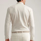 A man is shown from the back against a plain background wearing the Peter Millar Amble Long-Sleeve Cotton Cashmere Polo in light beige with matching pants, adding a refined touch to his understated look.