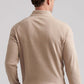 A man is seen from behind wearing the Peter Millar Grant Birdseye Quarter-Zip, a light beige long-sleeve top, paired with light pants, standing against a plain background.