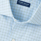 The Bechet Performance Poplin Sport Shirt by Peter Millar features a light blue and white checkered pattern and is made from performance fabric for comfort and style.