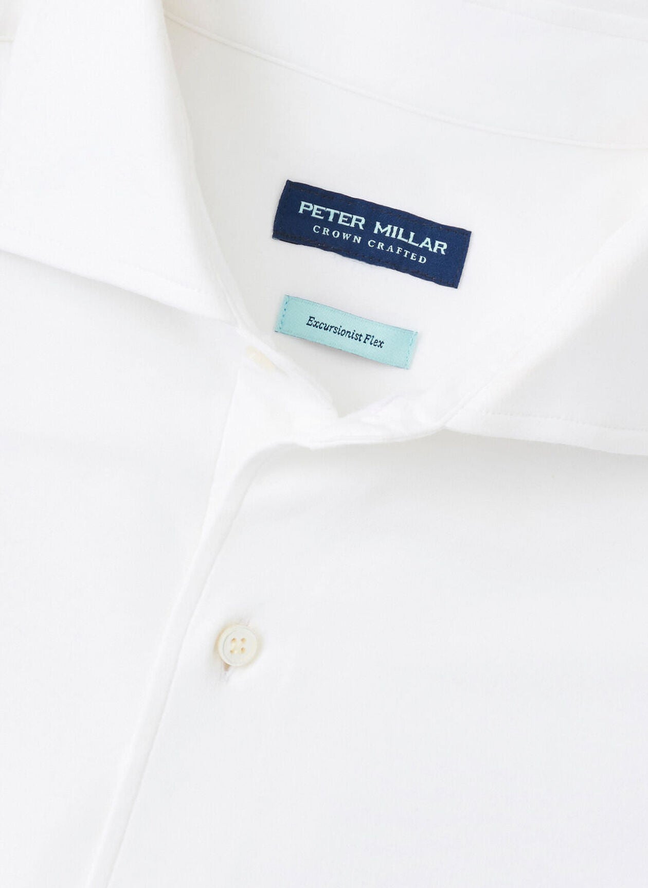 Close-up of the Peter Millar Excursionist Flex Solid Sport Shirt, showing labels inside the collar and crafted from wrinkle-resistant cotton-stretch fabric.