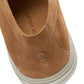 Close-up of the Excursionist Nubuck Venetian Loafer by Peter Millar: tan water-resistant nubuck, white stitching, crown logo on the heel, "PETER MILLAR" on the insole, and a white rubber sole offer lightweight versatility.