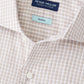 Close-up of the Peter Millar Torino Cotton Sport Shirt in beige and white checks, made from stretch cotton and detailed with buttons and a "Crown Crafted" label.