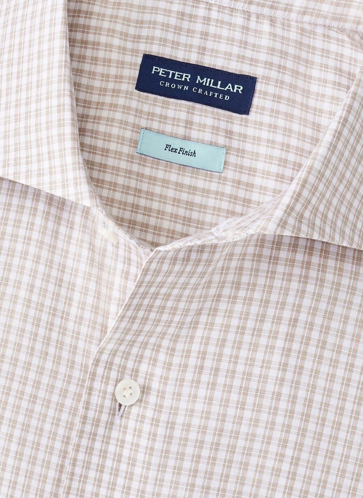 Close-up of the Peter Millar Torino Cotton Sport Shirt in beige and white checks, made from stretch cotton and detailed with buttons and a "Crown Crafted" label.