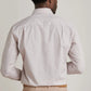A man is seen from behind in a Peter Millar Orvieto Cotton Sport Shirt and beige pants, standing against a plain light background.