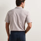 Back view of a person wearing a brown and white striped Turner Crown Flex Cotton Polo and dark pants, crafted from jersey-knit cotton for all-day comfort.