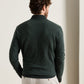Back view of a person wearing a dark green Blair Birdseye Quarter-Zip Sweater and light-colored trousers.