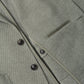 Close-up of a sage green Peter Millar Barclay Knit Soft Jacket featuring a button-front closure and a chest welt pocket.