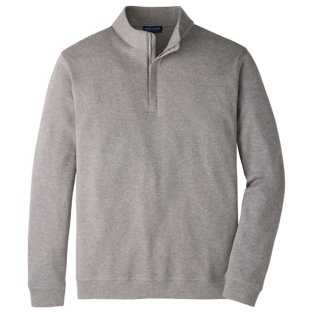 The Peter Millar Grant Knit Quarter-Zip is a light gray pullover sweater, expertly crafted from a luxurious cotton-cashmere blend. It features a stand-up collar, long sleeves, and ribbed cuffs and hem, shown against a white background.