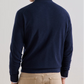 A person viewed from the back, wearing a navy blue Peter Millar Excursionist Flex Full Zip Sweater and tan trousers.