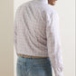 A man wears a Peter Millar Otis Cotton Sport Shirt, featuring a multicolored grid pattern on white cotton poplin, tucked into light-wash blue jeans with a tan belt.
