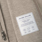 Close-up of the tan interior of a Peter Millar Crown Flex Merino Blazer, highlighting the product label with material details and icons for soft touch, two-way stretch, and warmth.