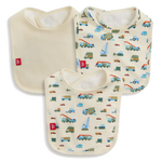 The Magnetic Me Dumps Like A Truck Modal Bib 3-Pack includes one solid cream and two vehicle-patterned bibs (cars, trucks, buses), all with white trim and red logo tags. Made from soft, eco-friendly modal for baby's comfort.