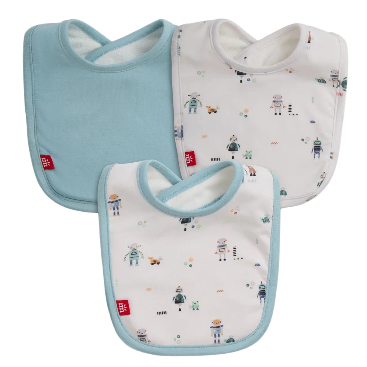 The Magnetic Me Love You Bot Modal Bib 3-Pack includes one solid light blue bib and two white bibs with blue trim, adorned with robot and animal prints. All are eco-friendly modal with a red logo tag at the bottom left corner.