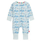 The Magnetic Me Baby Apres Chic Modal Convertible Coverall features a light blue mountain and skier pattern, sustainable modal fabric, light blue cuffs, multicolor stripe collar lining, and easy magnetic closures.