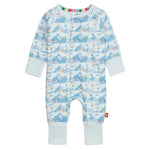 The Magnetic Me Baby Apres Chic Modal Convertible Coverall features a light blue mountain and skier pattern, sustainable modal fabric, light blue cuffs, multicolor stripe collar lining, and easy magnetic closures.