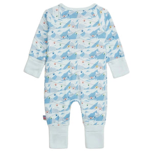 The Magnetic Me Baby Apres Chic Modal Convertible Coverall features a blue mountain and chalet print, long sleeves, white cuffs, and sustainable modal fabric for comfort. Its convertible design adapts as your baby grows.