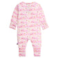 The Magnetic Me Baby Apres Chic Modal Convertible Coverall is a pink, long-sleeve infant onesie with white unicorns and flowers, crafted from sustainable modal fabric and shown flat with the back facing up.