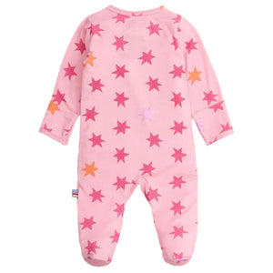 The Magnetic Me Baby Girls' Cosmic Confetti with Foil Modal Footie is a pink long-sleeve sleeper with pink and orange star patterns, covered feet, easy magnetic closures, and a rainbow side tag.