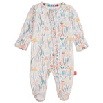 The Magnetic Me Baby Girls' Shroom and Bloom with Ruffle Modal Magnetic Footie features sustainable modal, a colorful floral and woodland print, magnetic front closures, enclosed feet, and cozy ruffle details.