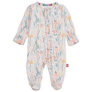 The Magnetic Me Baby Girls' Shroom and Bloom with Ruffle Modal Magnetic Footie features sustainable modal, a colorful floral and woodland print, magnetic front closures, enclosed feet, and cozy ruffle details.