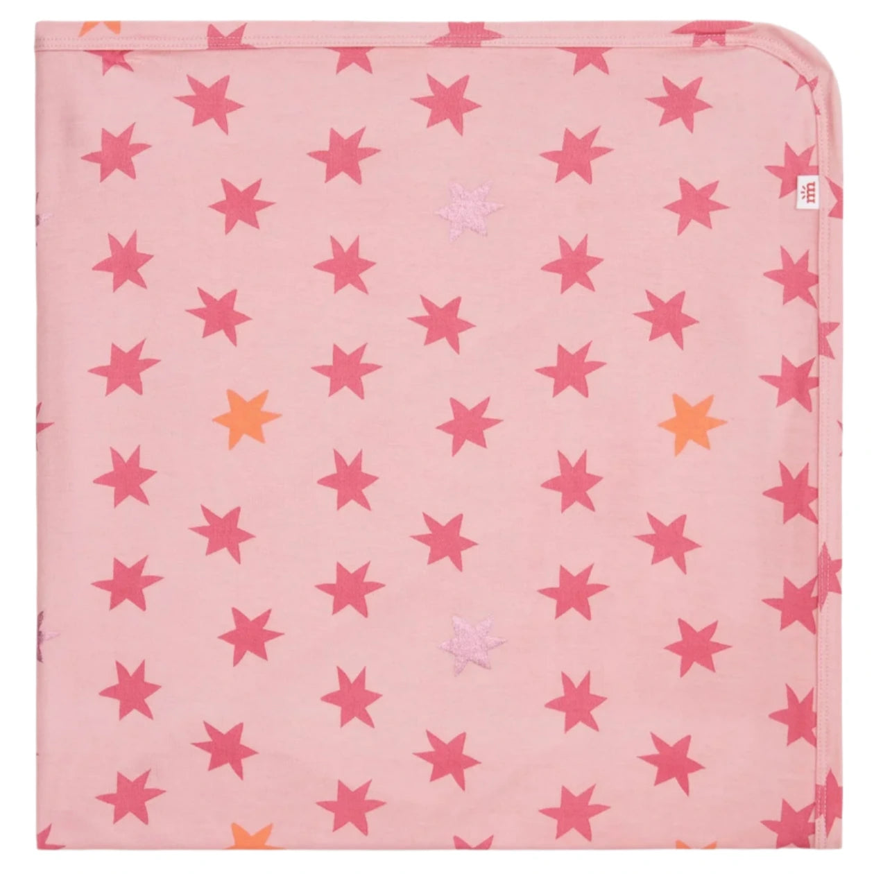 The Cosmic Confetti Baby Blanket by Magnetic Me is a pink square stroller blanket with red, orange, and light pink stars, one rounded corner, and a white tag—made from temperature-regulating fabric for your baby’s comfort.